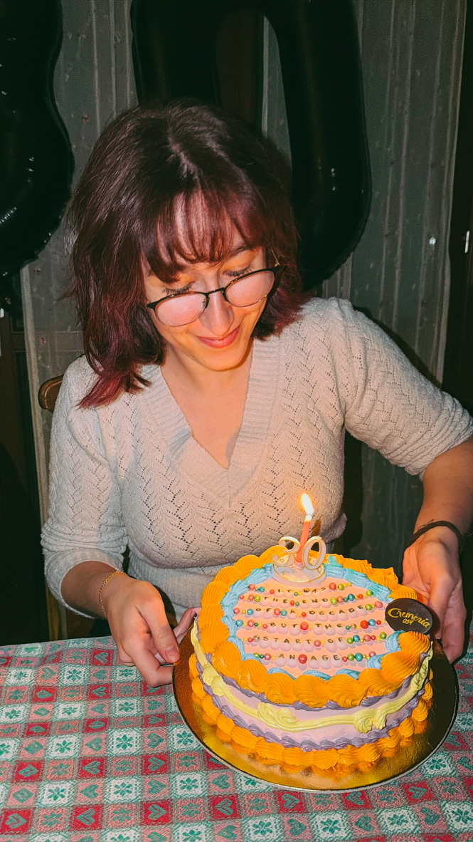 Francesca with a birthday cake, smiling